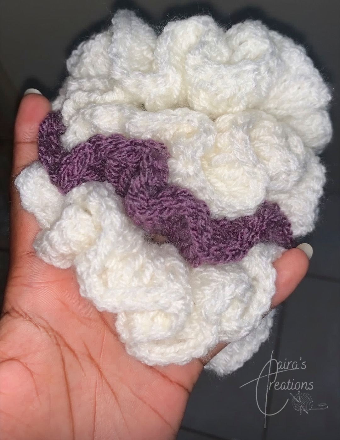 Fluffy scrunchies, cream crochet scrunchie with purple, held in hand