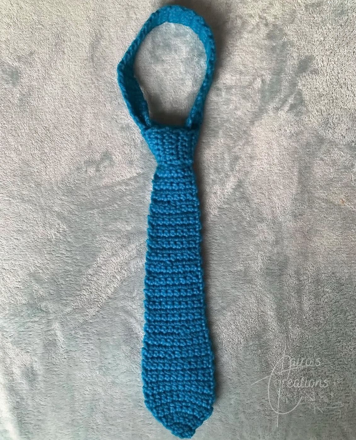 Cobalt blue crochet necktie laid flat, gifts for dads, statement piece